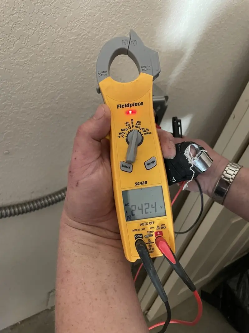 Voltage testing with clamp meter during Outlet Installation in Superior